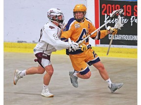 The Calgary Mountaineers' Cody Arsenault, left, battles the Coquitlam Adanacs' Dennon Armstrong during Minto Cup lacrosse action at the Max Bell Arena in Calgary on Thursday August 16, 2018.  Gavin Young/Postmedia