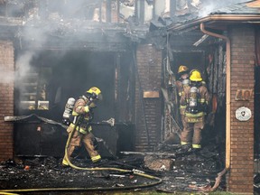 Calgary firefighters extinguish a house fire on Templeby Drive N.E on Saturday afternoon August 18, 2018. Neighbours say the fire started and spread quickly and the residents escaped unharmed.  Gavin Young/Postmedia