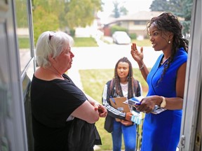 Bettina Pierre-Gilles, who is running for the UCP nomination for Calgary-Currie, talks with Westgate resident Wendy Hunt. Pierre-Gilles was door-knocking in the neighbourhood on Aug. 18, 2018, with her daughter Greta.