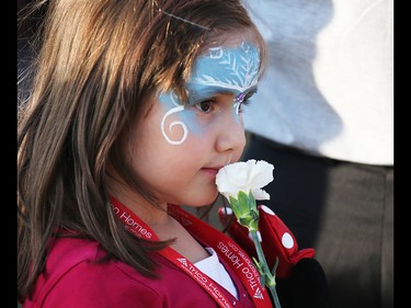 Liana Lisa holds a flower as she watches her mom become a Canadian citizen during a citizenship ceremony at Globalfest on Tuesday, August 21, 2018. The Philippines put on the show fireworks show for the night.