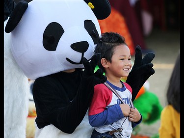 Five year-old Matthew Carpento, 5, has some with a panda at China's booth at Globalfest on Tuesday, August 21, 2018. The Philippines put on the show fireworks show for the night.