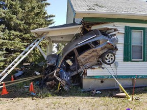 The scene in Coaldale where a car flew off the highway and hit a house. Photo courtesy the RCMP