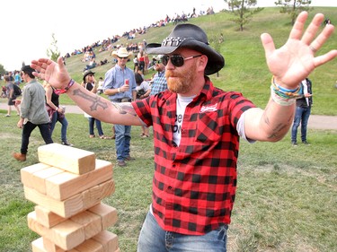 Rich Boutilier celebrates a successful Jenga move during day three of the 3rd annual Country Thunder music festival held at Prairie Winds Park in northeast Calgary Sunday, August 19, 2018. Dean Pilling/Postmedia