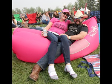 Brooke and Michael Watson  relax while taking in the music during day three of the 3rd annual Country Thunder music festival held at Prairie Winds Park in northeast Calgary Sunday, August 19, 2018. Dean Pilling/Postmedia