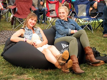 Julie Murrell and Sidney Paulson relax while Restless Heart performs on day two of the 3rd annual Country Thunder music festival held at Prairie Winds Park in northeast Calgary Saturday, August 18, 2018. Dean Pilling/Postmedia