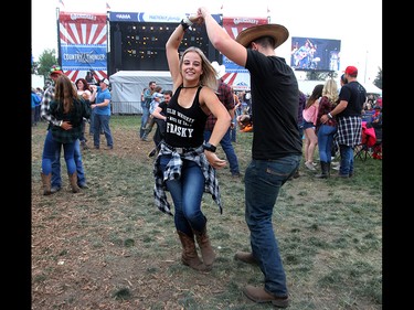 Music fans dance along as Midland performs during day three of the 3rd annual Country Thunder music festival held at Prairie Winds Park in northeast Calgary Sunday, August 19, 2018. Dean Pilling/Postmedia