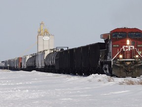 A CP Rail locomotive hauls grain and oil cars. The Alberta government has announced it is buying more rail cars to move oil out of the province.
