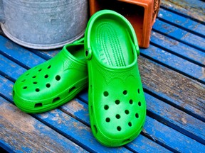 Green Garden Clogs On A Blue Table