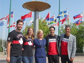 Mary Moran (C) poses with athletes at Winsport after being announced as Calgary Olympic Bid Corporation CEO in Calgary on Tuesday, July 31, 2018. Jim Wells/Postmedia