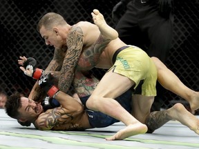 Renato Moicano, top, hits Cub Swanson during their featherweight mixed martial arts bout at UFC 227 in Los Angeles, Saturday, Aug. 4, 2018.