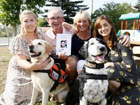 L-R, Partner, Ciara O'Malley, Dad, Michael Gavin, Wife, Angela and daughter, Aoife, family of David Gavin thank L-R, Bruce and Sailor from the Canadian Canine Search Corps after making a donation to the Calgary Canine Search Core at the Irish Cultural Society Calgary. David disappeared while swimming last summer in a lake north of Revelstoke, B.C. on Tuesday August 21, 2018. Darren Makowichuk/Postmedia