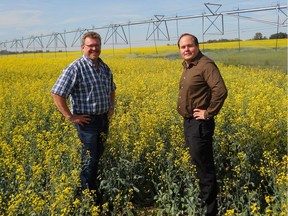 Board chairman Ray Kettenbach, left, and David McAllister, general manager of Western Irrigation District, on irrigated farm land. Celebrating 75 years running canal system in 2019. Supplied photo for David Parker column. July 2018