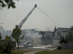 Firefighters at the scene of a multiple house fire on Los Alamos Cres N.E. in Calgary, on Friday August 10, 2018. Leah Hennel/Postmedia
