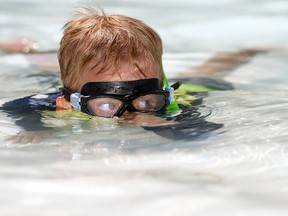 Kieran Henderson,6, cools down at the Bowness Park Wading pool as the heat wave continues in Calgary on Thursday Aug. 9, 2018.