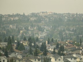 A smoke covered northwest Calgary is obscrured as seen from Country Hills Golf Course on Saturday, Aug. 11, 2018.