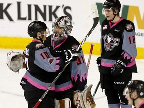 Calgary Hitmen L-R, Jakob Stukel and Nick Schneider have words after losing their last game as Hitmen to the Edmonton Oil Kings at the Scotiabank Saddledome in Calgary on Sunday, March 18, 2018. Darren Makowichuk/Postmedia