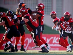 Calgary Stampeders quarterbacks Ricky Stanzi hands off to running back Romar Morris during CFL pre-season football in Calgary on Friday, June 1, 2018. Al Charest/Postmedia