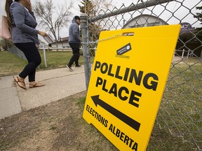 People enter a polling station at Meadowlark Christian School in Edmonton on May 5, 2015 during the provincial election.