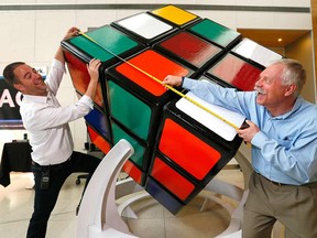 Designer Wes Nelson and Robert Leedham measure the newest WORLD'S LARGEST functioning Rubik's cube that TELUS Spark revealed in Calgary on Wednesday August 22, 2018.