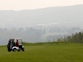 Golfers play through the haze at Lynx Ridge Golf and Country Club on Sunday, Aug. 19, 2018.