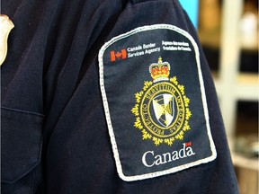 A Canadian Border Services Agency (CBSA) officer's shoulder flash is shown at the Calgary Courts Centre is shown in Calgary, Alta on Saturday April 22, 2017. Jim Wells//Postmedia