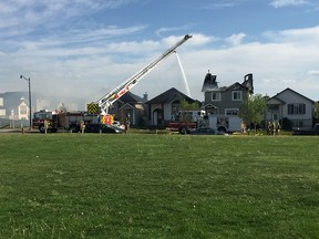 Firefighters respond to a fire that destroyed three homes in Taradale Monday.