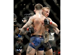 T.J. Dillashaw, right, hugs Cody Garbrandt after Dillashaw's win during their UFC title bantamweight mixed martial arts bout at UFC 227 in Los Angeles, Saturday, Aug. 4, 2018.