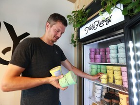 Marcus Purtzki, the founder and owner of Made By Marcus, on 17 Ave SW, organizes some stock on a potentially busy day in Calgary Friday, August 10, 2018.