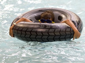 Brayden de Regt , 9, beat the smoke in Calgary by swimming inside at the Southland Leisure Centre on Thursday August 16, 2018. Leah Hennel/Postmedia