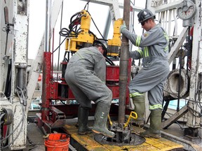 Trinidad Drilling floor hands work at a drilling rig at Turner Valley in this file photo. Trinidad is the target of a hostile takeover bid.