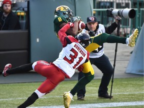 Edmonton Eskimos Kenny Stafford (8) makes the catch to score a touchdown on Calgary Stampeders Tre Roberson (31) during third quarter CFL action at Commonwealth Stadium in Edmonton on Saturday. Photo by Ed Kaiser/Postmedia