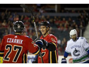 Calgary Flames Austin Czarnik, left, celebrates his goal with teammate Mikael Backlund during their game against the Vancouver Canucks at the Scotiabank Saddledome in Calgary, Alta. on Saturday September 22, 2018. Leah Hennel/Postmedia