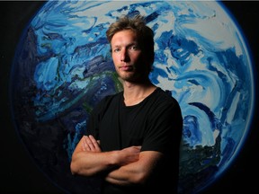 Artist Erik Olson with his work at the Glenbow Museum  in Calgary.