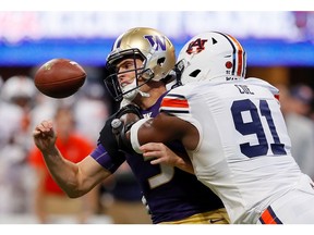 ATLANTA, GA - SEPTEMBER 01:  Nick Coe #91 of the Auburn Tigers forces a fumble as he knocks the ball from the hands of Jake Browning #3 of the Washington Huskies at Mercedes-Benz Stadium on September 1, 2018 in Atlanta, Georgia.