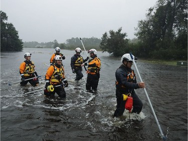 FAIRFIELD HARBOUR, NC - SEPTEMBER 14:  Members of the FEMA Urban Search and Rescue Task Force 4 from Oakland, California, search a flooded neighborhood for evacuees during Hurricane Florence September 14, 2018 in Fairfield Harbour, North Carolina. Hurricane Florence made landfall in North Carolina as a Category 1 storm and flooding from the heavy rain is forcing hundreds of people to call for emergency rescues in the communities around New Bern, North Carolina, which sits at the confluence of the Neuse and Trent rivers.