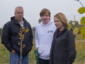 Tim Spurrell, left, along with his son Ryan and wife Lisa attended the McInnis & Holloway Memorial Forest Weekend on September 15th, 2018. The family was there to remember Lisa's late father, Fred Enns. (Zach Laing / Postmedia Network)