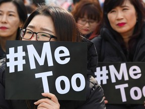 TOPSHOT - South Korean demonstrators hold banners during a rally to mark International Women's Day as part of the country's #MeToo movement in Seoul on March 8, 2018. The #MeToo movement has gradually gained ground in South Korea, which remains socially conservative and patriarchal in many respects despite its economic and technological advances.