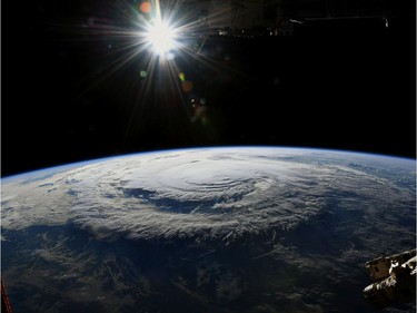 This  image obtained from NASA and taken on September 14, 2018, by astronaut Ricky Arnold from the International Space Station shows Hurricane Florence. - Florence smashed into the US East Coast Friday with howling winds, torrential rains and life-threatening storm surges as emergency crews scrambled to rescue hundreds of people stranded in their homes by flood waters. Forecasters warned of catastrophic flooding and other mayhem from the monster storm, which is only Category 1 but physically sprawling and dangerous.