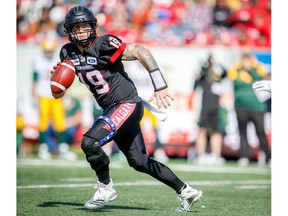 Calgary Stampeders quarterback Bo Levi Mitchell plays with leg brace after suffering leg injury during a game against the Edmonton Eskimos in the Labour Day Classic in Calgary on Monday, September 3, 2018. Al Charest/Postmedia