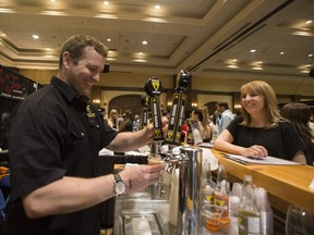 Darren McJannet of Canmore's Grizzly Paw Brewing Company pours out a sample during the Rocky Mountain Wine and Food Festival in Banff in 2014. The Calgary edition of the festival goes Friday, Oct. 12 and Saturday, Oct. 13.