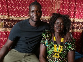 Wil Konybai and his mom Nyidear Dut were photographed at home in Calgary on Tuesday September 4, 2018. Nyidear brought Will and his three brothers from Sudan 13 years ago. When Will almost dropped out of school a unique United Way program helped him stay in school now he's a university graduate and just finished working for the United Way for the summer. Gavin Young/Postmedia