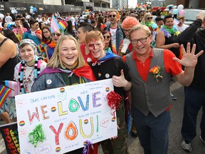 Alberta Minister of Education David Eggen marches with students Madison Jones, left, and Clayton Poirier in the 2018 Pride Parade in Calgary on Sunday, Sept. 2, 2018.