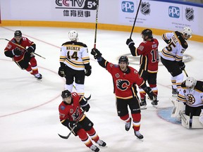 Members of the Calgary Flames, from left, Johnny Gaudreau, Austin Czarnik, James Neal, and Derek Ryan react during their game against the Boston Bruins in the 2018 NHL China Games in Shenzhen in southern China's Guangdong province, Saturday, Sept. 15, 2018. Boston beat Calgary 4-3 in a shootout. (Color China Photo via AP) ORG XMIT: XMAS807