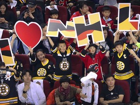 Young Chinese fans hold letters spelling out "I (love) NHL" before the start of the 2018 NHL China Games hockey game between the Boston Bruins and the Calgary Flames in Beijing on Wednesday, Sept. 19, 2018.