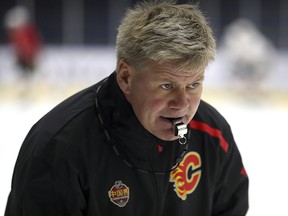 Calgary Flames head coach Bill Peters puts his team through the paces during practice in Beijing on Monday, Sept. 17, 2018.