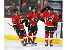 Flames Andrew Mangiapane (L) Dillon Dube (C) and Spencer Foo celebrate Dube's first-period goal during an NHL pre-season rookie game between the Edmonton Oilers and Calgary Flames in Calgary on Sunday, September 9, 2018. Jim Wells/Postmedia