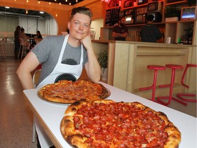 Mike Lange, of Noble Pie, poses inside Eighty-Eight Brewing company in southeast Calgary with two of his custom pizzas  Friday, September 14, 2018. One pie, called The Roni, is a triple pepperoni and banana peppers. The pepperoni is imported from Ohio. The second pizza, called "Sweet Cheesus" is a five-cheese pizza and them drizzled with Mike's Hot Honey Drizzle from Brooklyn, N.Y. Jim Wells/Postmedia