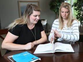 Ashley Jensen, left, discusses math with daughter Bradley in their northwest home in Calgary on Friday, September 21, 2018. The teen benefited from attending a summer school math program, which better prepared the student for Grade 10 math courses.