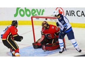 Calgary Flames Mike Smith gives up a goal to C.J. Suess of the Winnipeg Jets during NHL pre-season hockey at the Scotiabank Saddledome in Calgary on Monday, September 24, 2018. Al Charest/Postmedia