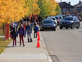 Parents line up in vehicles to pick up students at New Brighton Elementary School on Monday afternoon, Sept. 17, 2018. The Calgary Parking Authority is cracking down on congestion in front of schools.